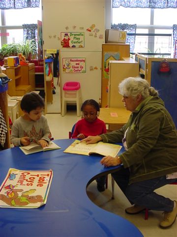 Grandma Martha helping the CEEC children learn to read